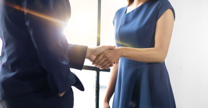 Client and social influencer shaking hands accepting partnership on influencer marketing campaign